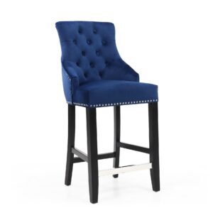 Dark blue tufted bar stool with black legs and silver nailhead trim. The chair exudes a sophisticated and elegant tone, enhancing modern decor.
