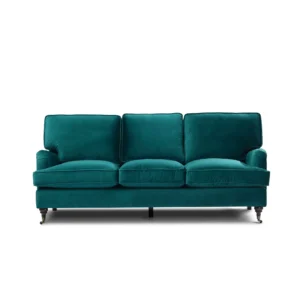 A teal velvet sofa with three seat cushions and plush backrests, evoking a sense of luxury and comfort. It has dark wooden legs with casters.