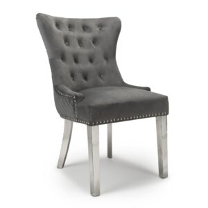 Elegant gray velvet chair with a high back, button tufting, and silver nailhead trim. It has silver legs, exuding a luxurious, modern feel.