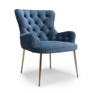 Elegant blue velvet armchair with tufted backrest and brass legs, conveying a sense of luxury and comfort. The design is modern and inviting.