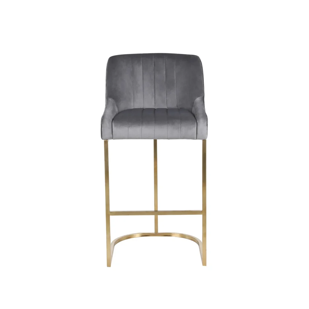 Gray velvet barstool with a curved backrest and vertical stitching, featuring sleek gold metal legs. The design is modern and elegant.
