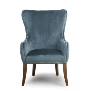 Elegant blue velvet armchair with high back, silver nailhead trim, and wooden legs. The chair conveys a sense of luxury and comfort.